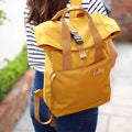 Person wearing a backpack with 'personalised name in mustard.  