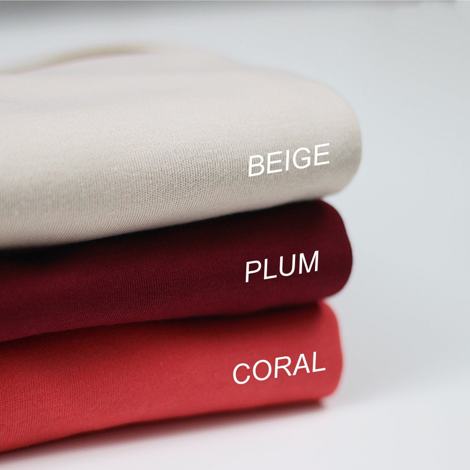 Stack of fabric swatches in beige, plum, and coral with labels on a light background.