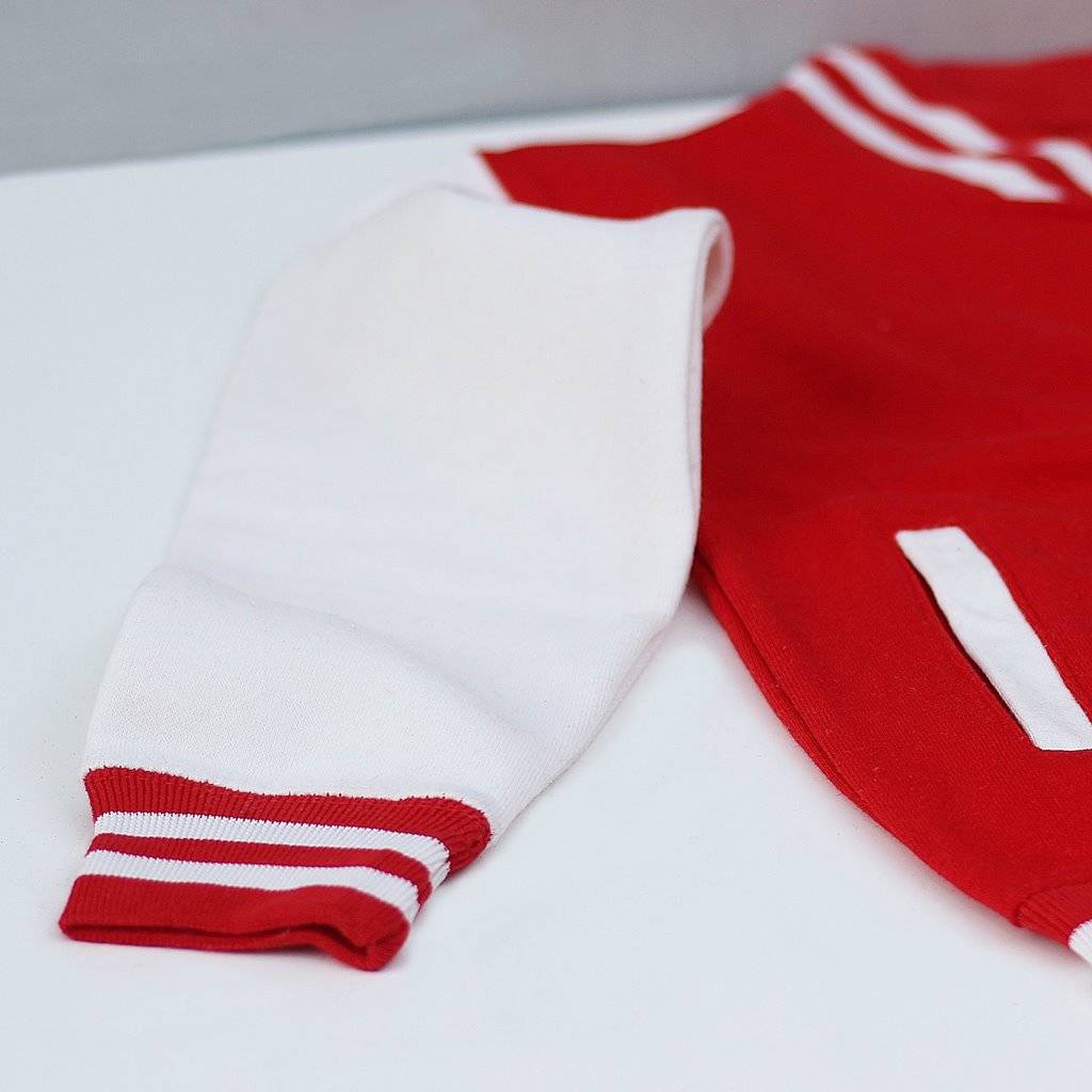 Red and white sports jersey on a light gray background
