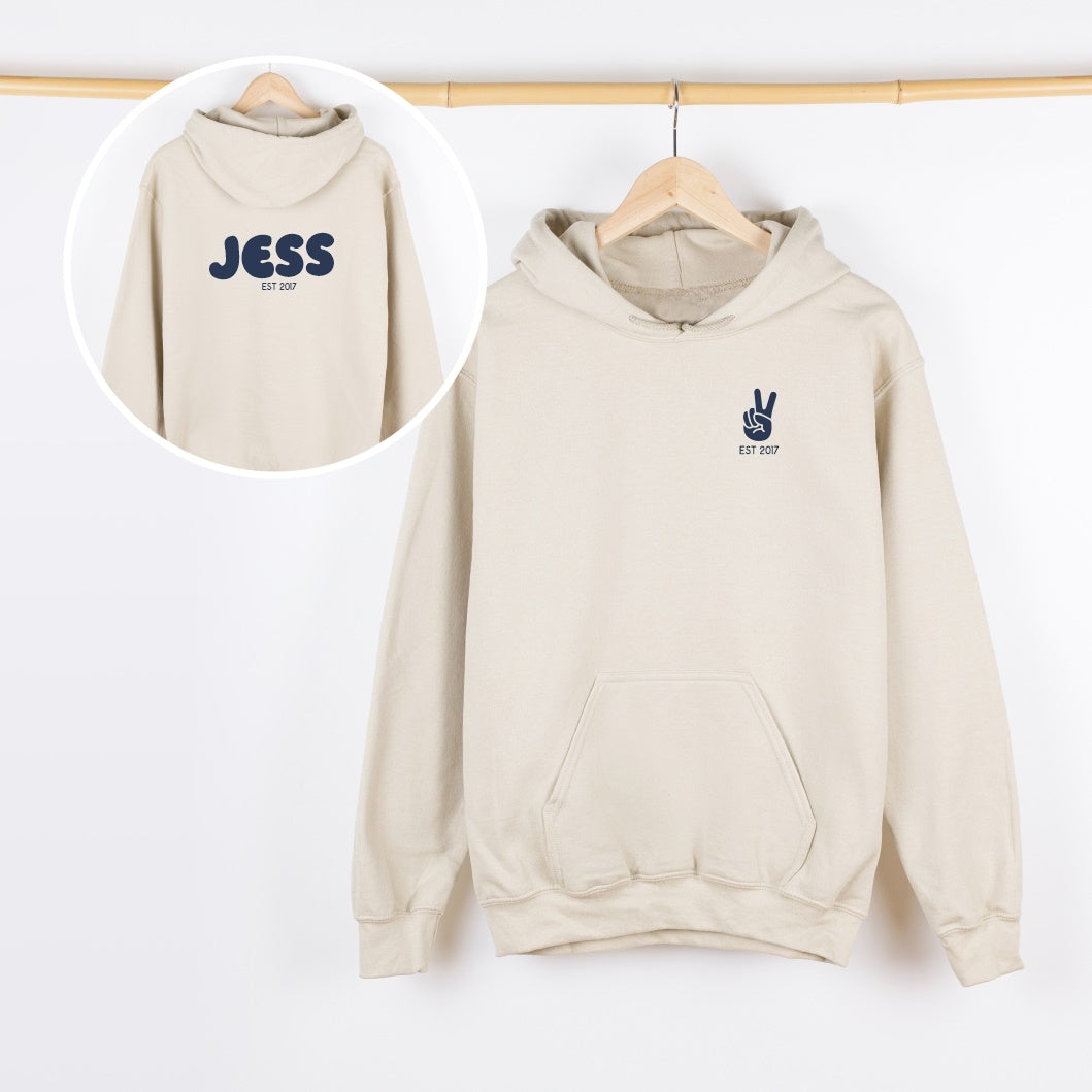Beige hoodie with 'JESS' branding on a white background
