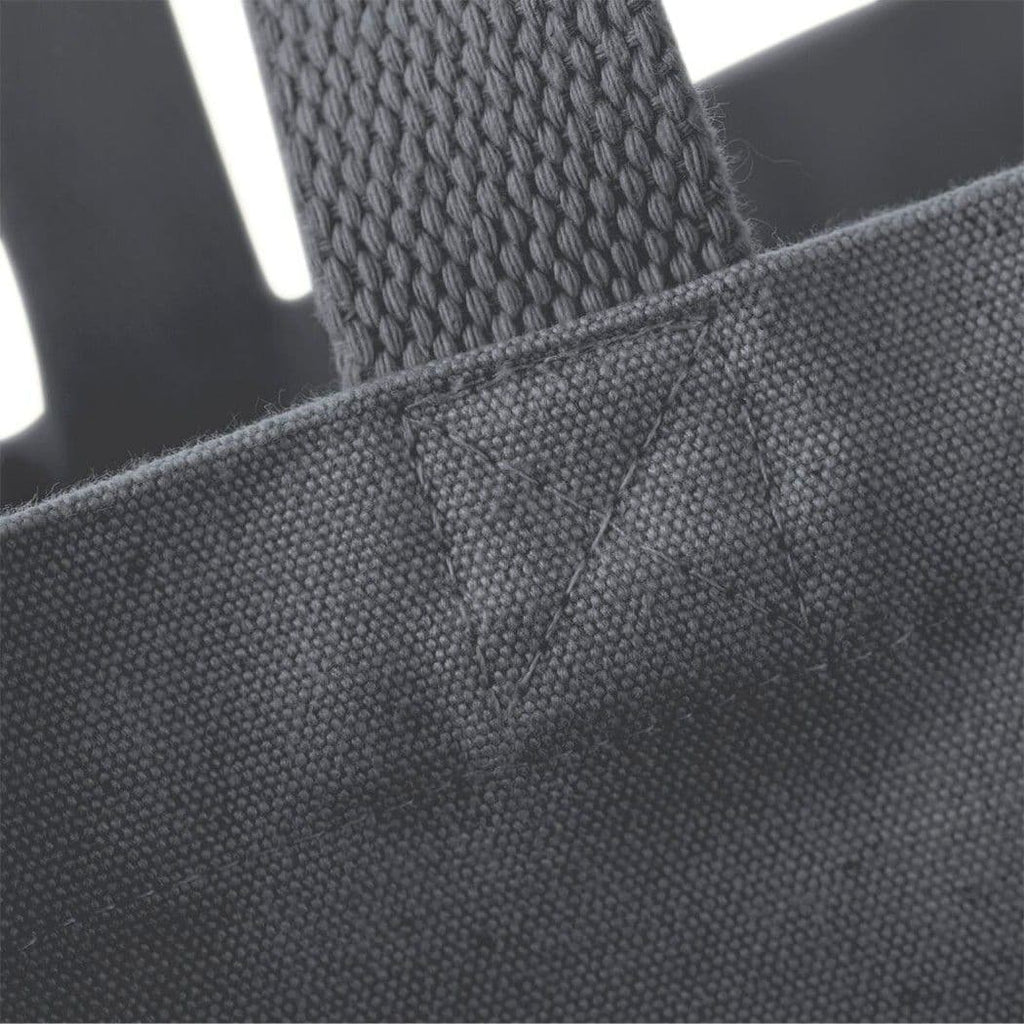 Close-up of a dark gray tote bag with a textured handle.
