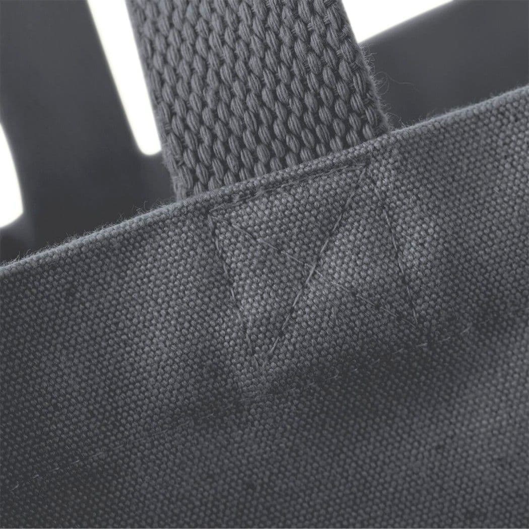 Close-up of a dark gray tote bag with a textured handle.