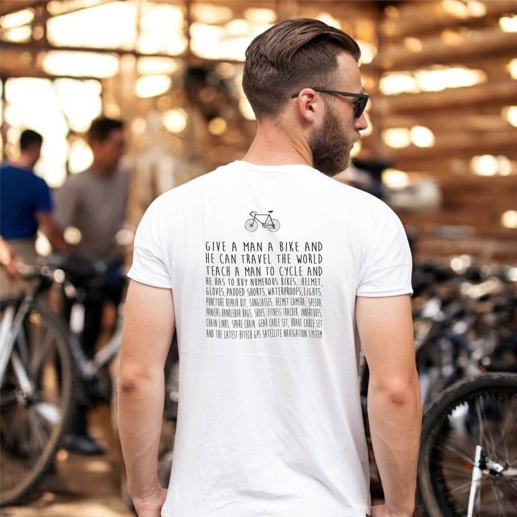 Man wearing a white t-shirt with text and bicycle graphic, standing in a bike shop.