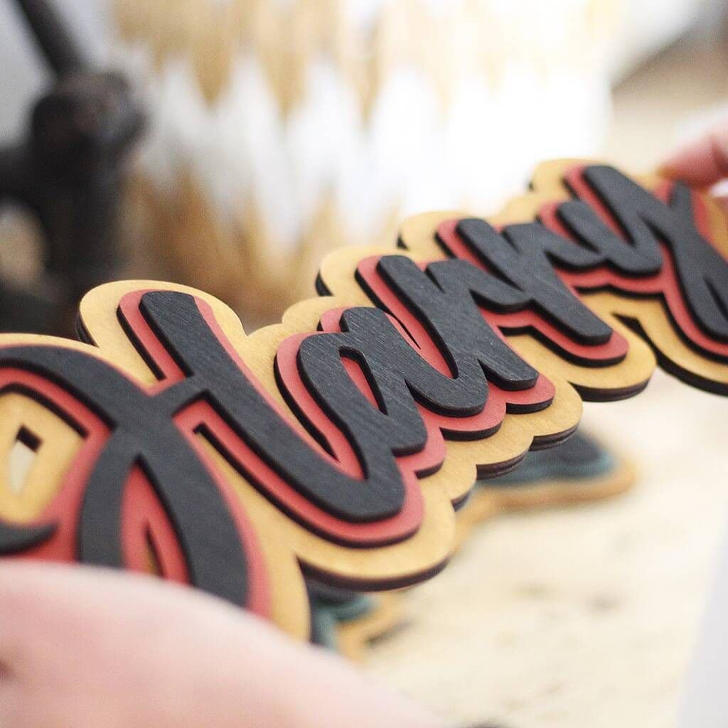 Colorful 'Harry' cookies on a wooden surface with a blurred background