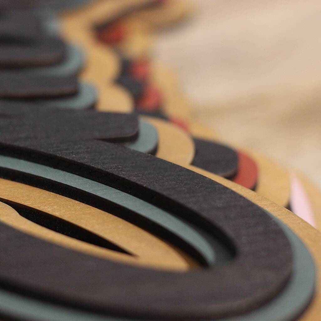 Close-up of a textured surface with geometric patterns in brown, black, and red.