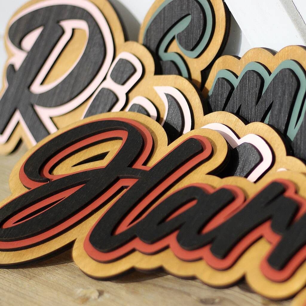 Wooden letters spelling 'Pine Bar' on a wooden surface