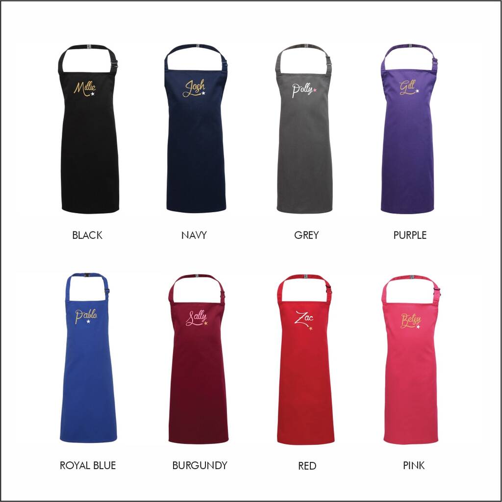 Collection of aprons in various colors with embroidered names on a white background.