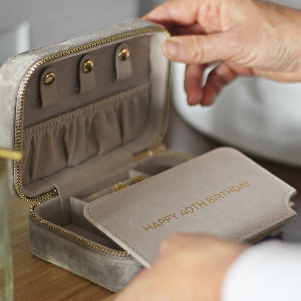 Gray jewelry case with 'Happy 40th Birthday' message, held by a hand.