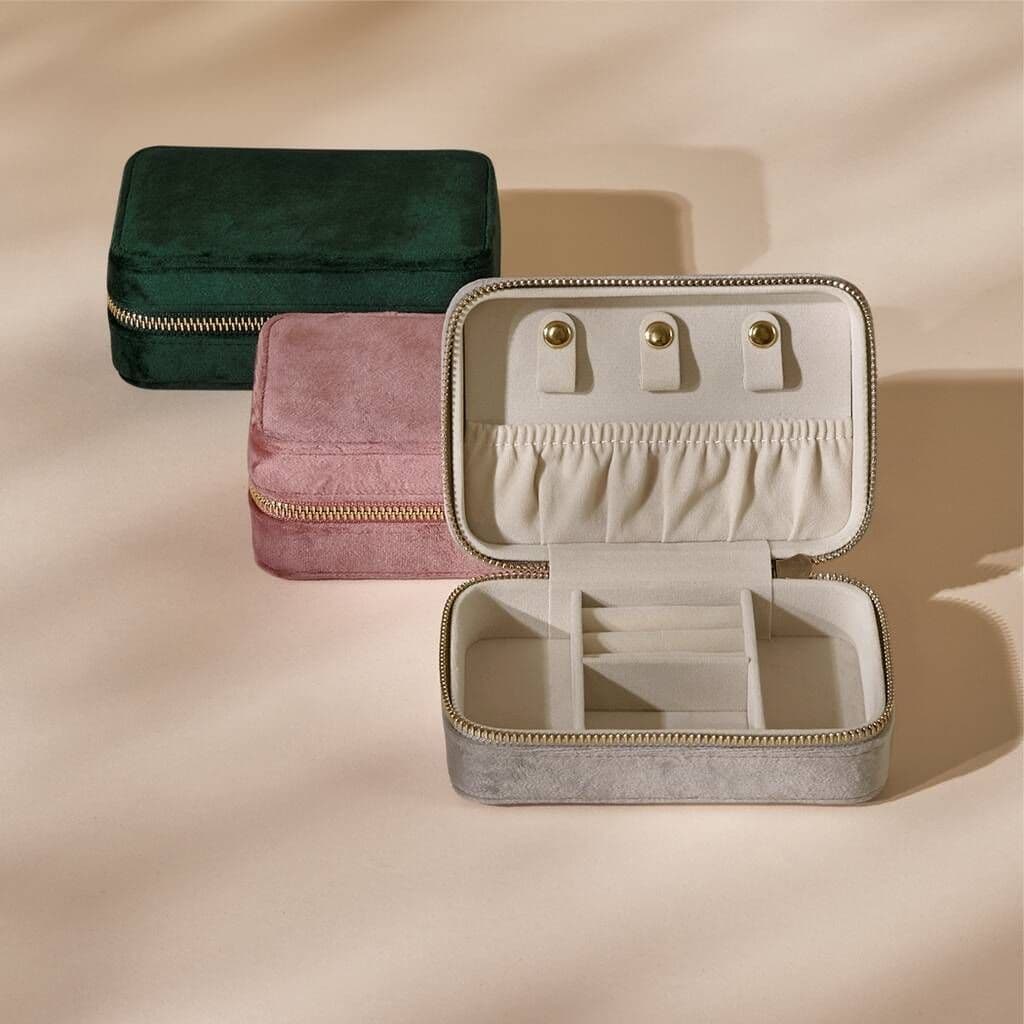Jewelry case with earrings on a beige background