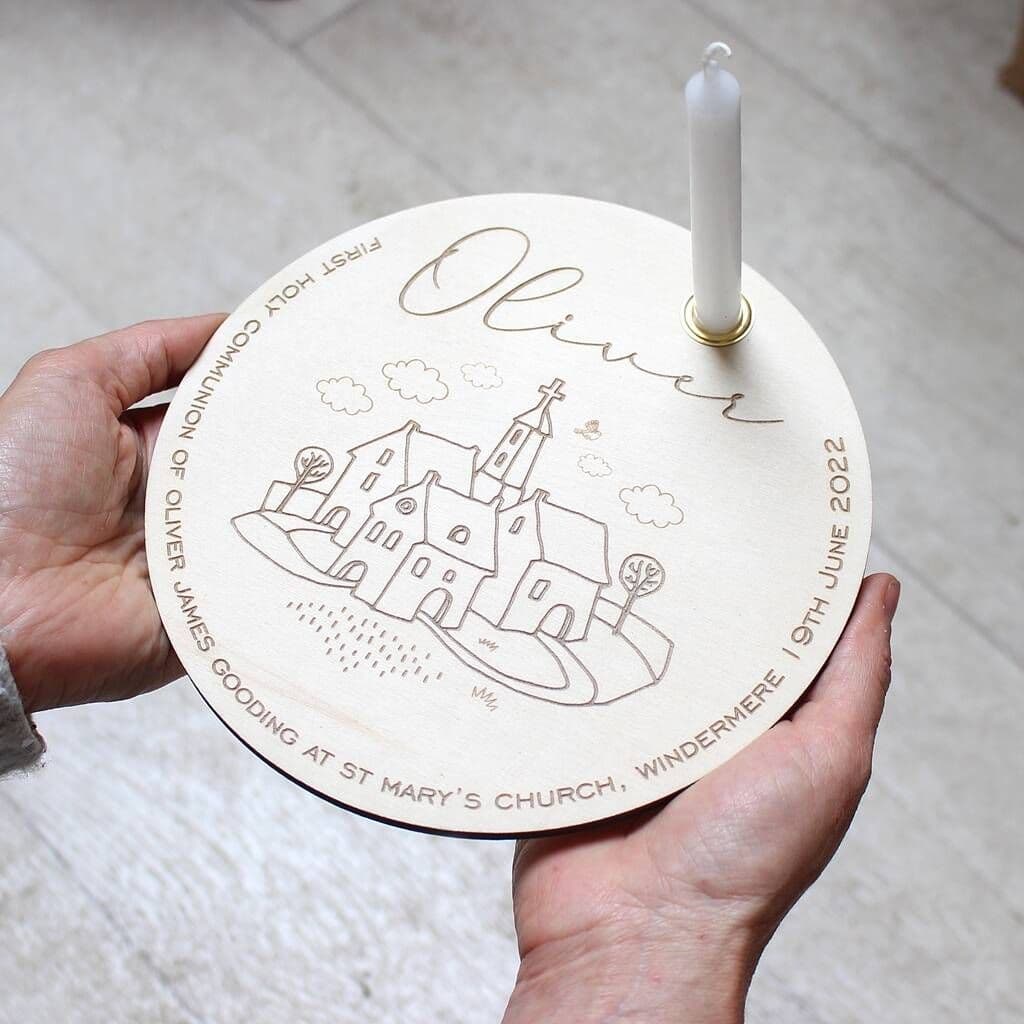 Round wooden plaque with engraved design and text, held by a hand on a light background