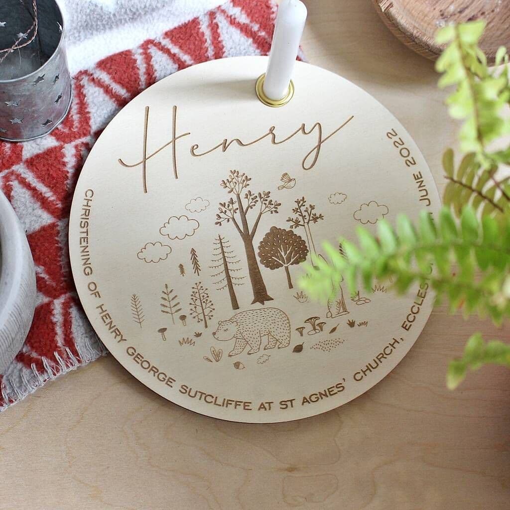 Round wooden plaque with engraved design and text on a wooden surface.