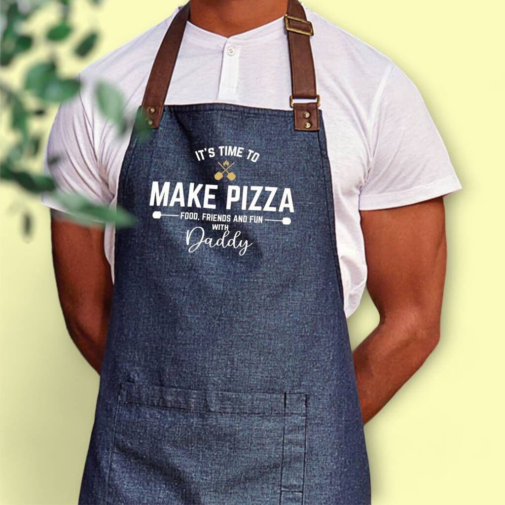 Person wearing a denim apron with a printed message on a light yellow background