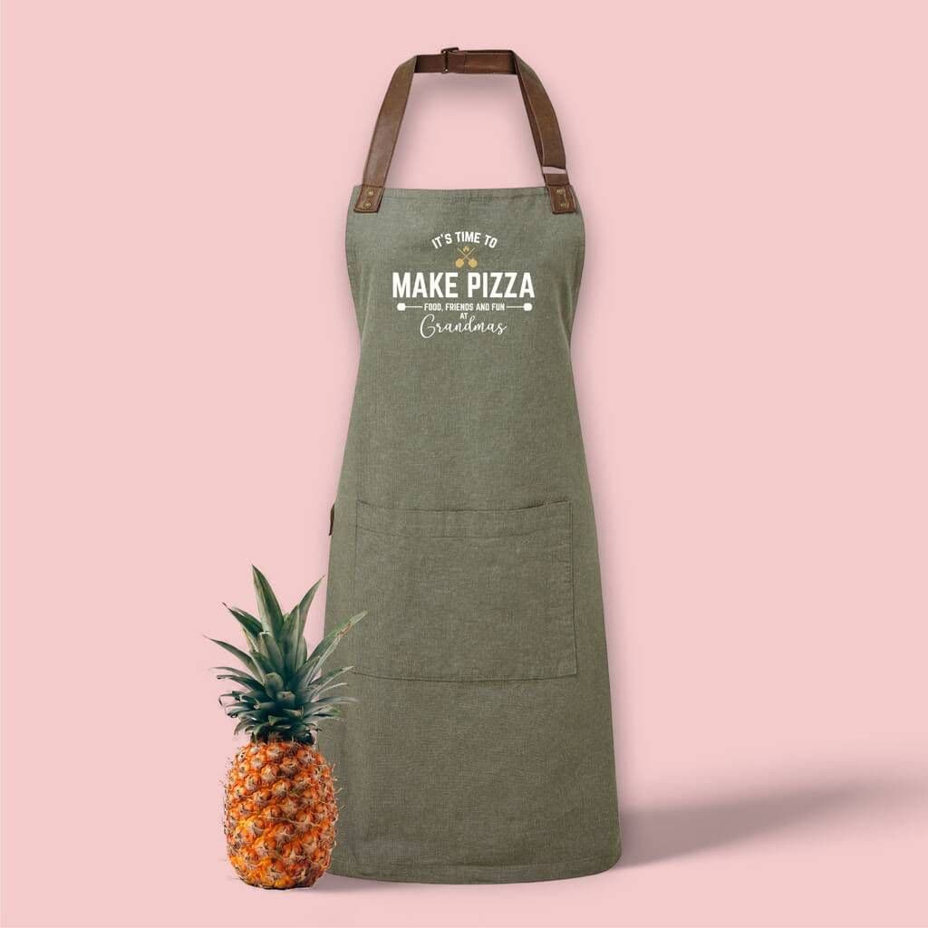 Green apron with text and pineapple on a pink background