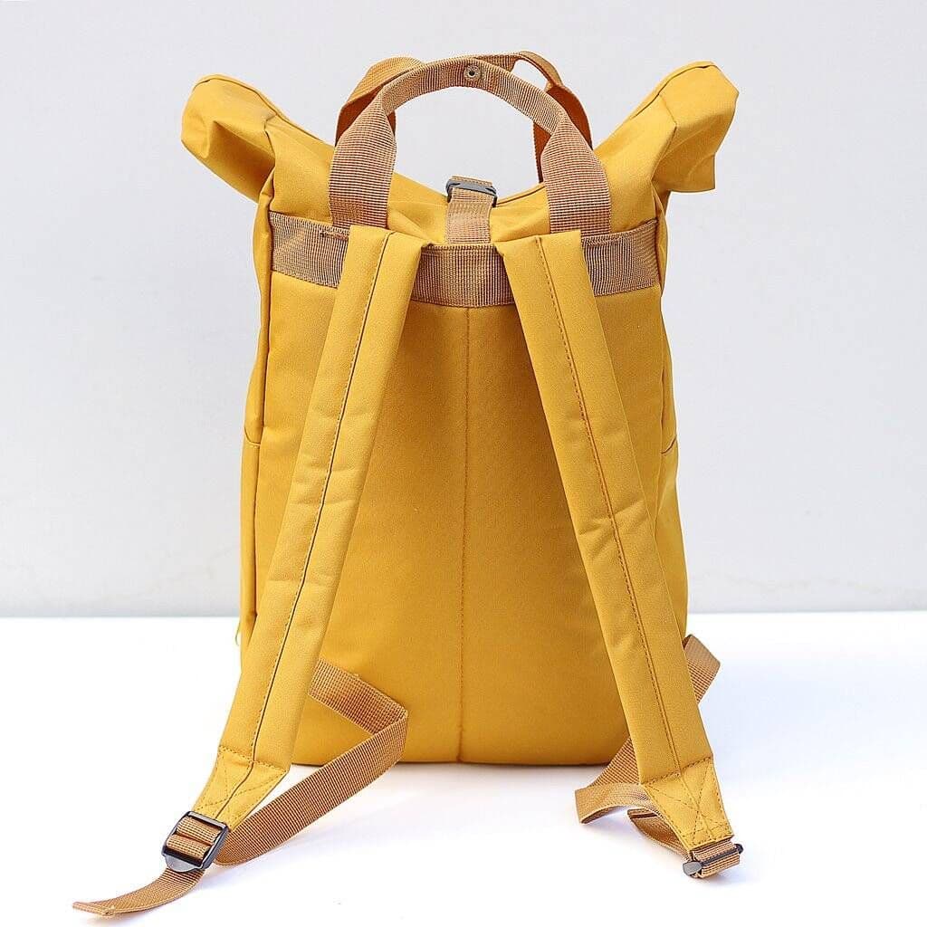 Back view mustard — Back view of mustard yellow recycled roll top backpack showing padded adjustable shoulder straps