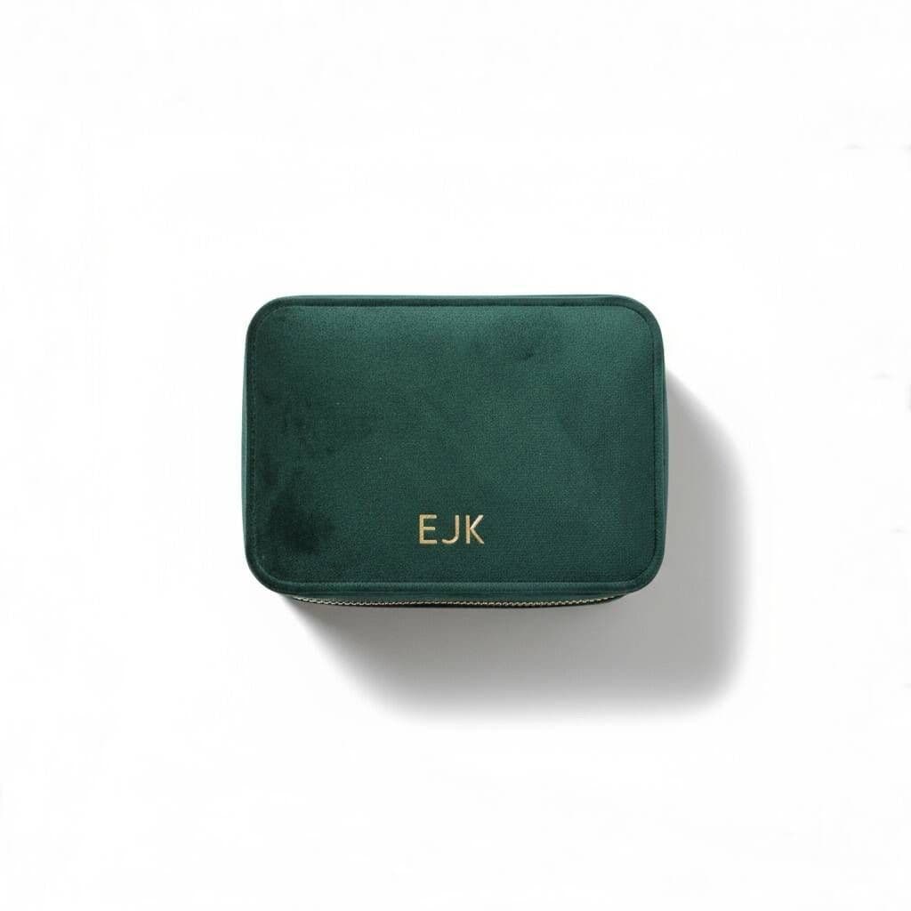 Green rectangular pouch with 'EJK' monogram on a white background