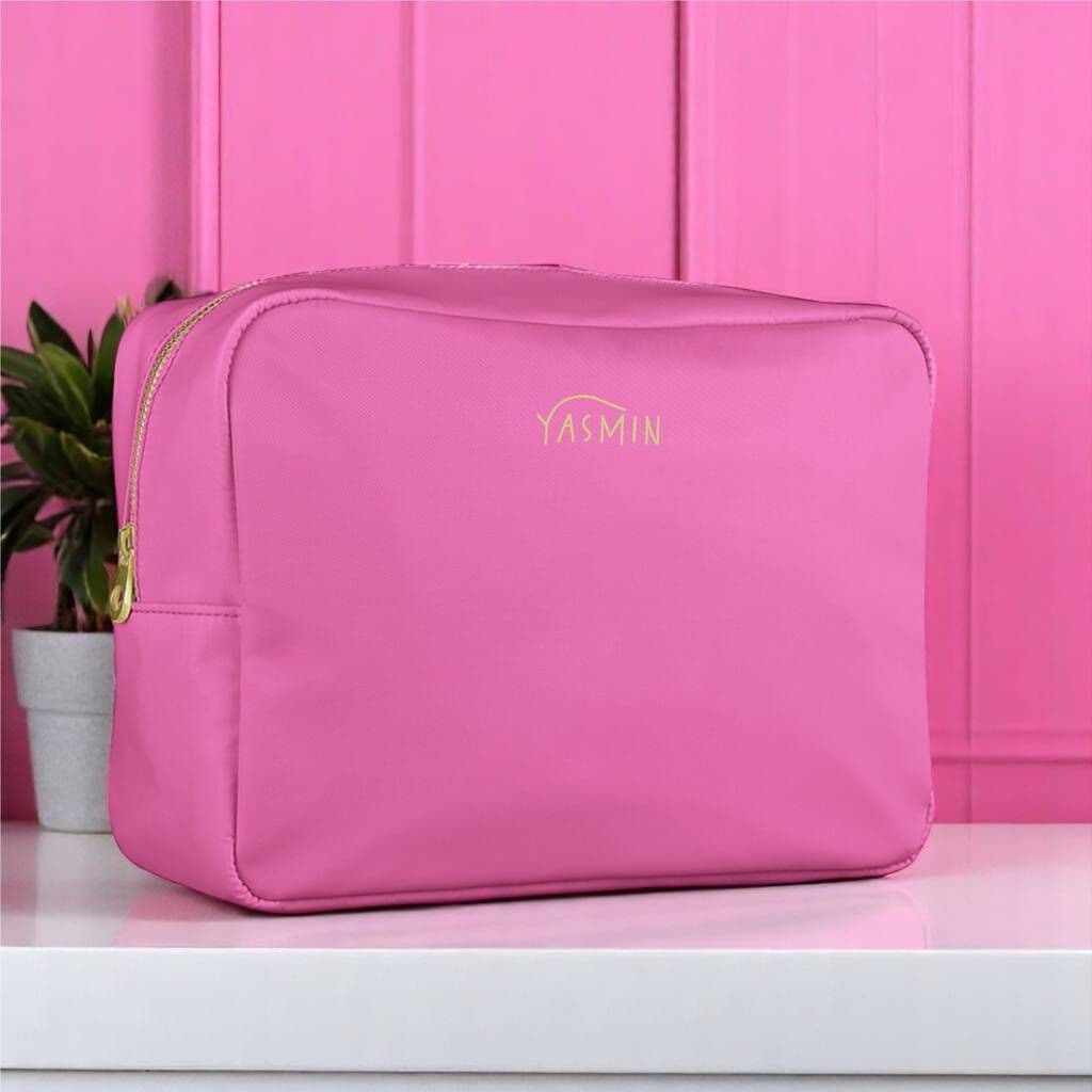 Pink toiletry bag with 'YASMIN' branding on a pink background