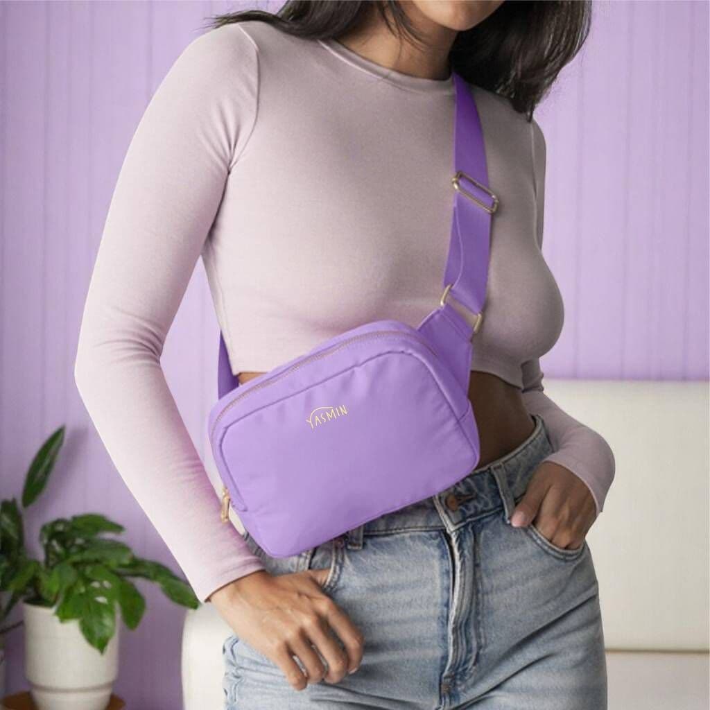 Person wearing a purple crossbody bag with a blurred background