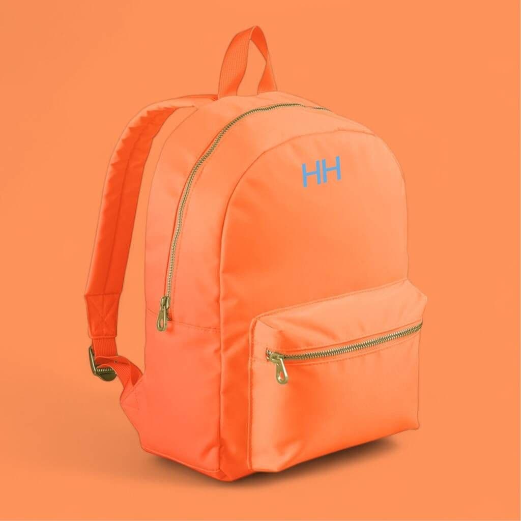 Orange backpack with a brand logo on an orange background