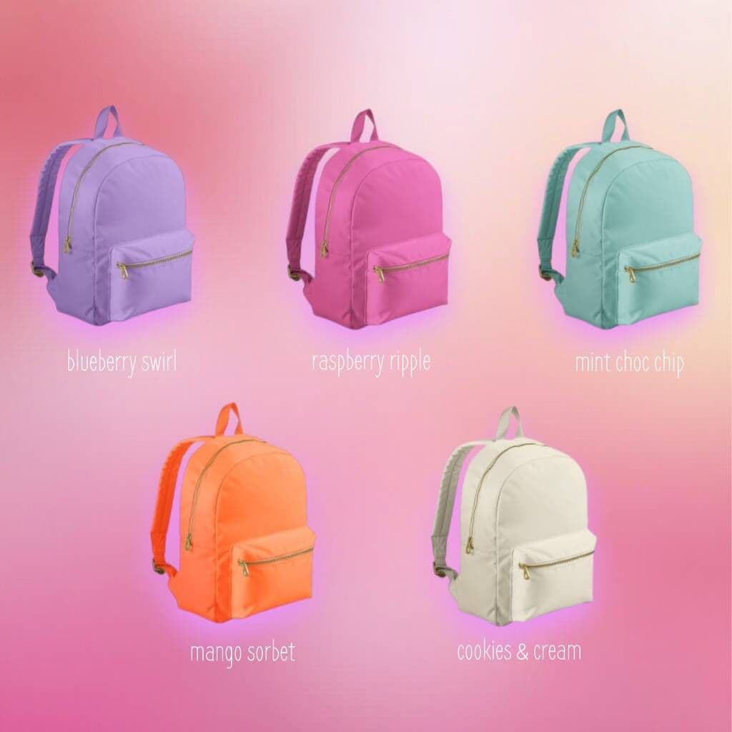 Five colorful backpacks on a gradient pink background