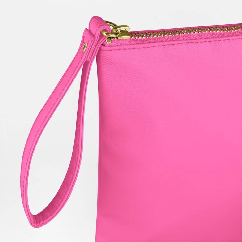 Close-up of a pink clutch bag with a gold zipper on a white background