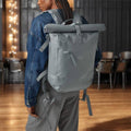 Person wearing a gray backpack with 'RD' initials in an indoor setting.