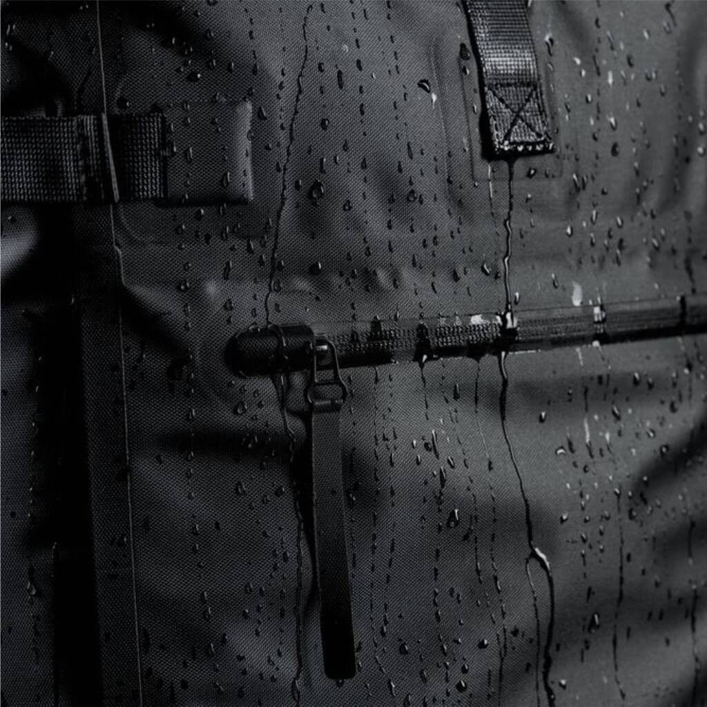 Close-up of a black tactical backpack with water droplets on the surface