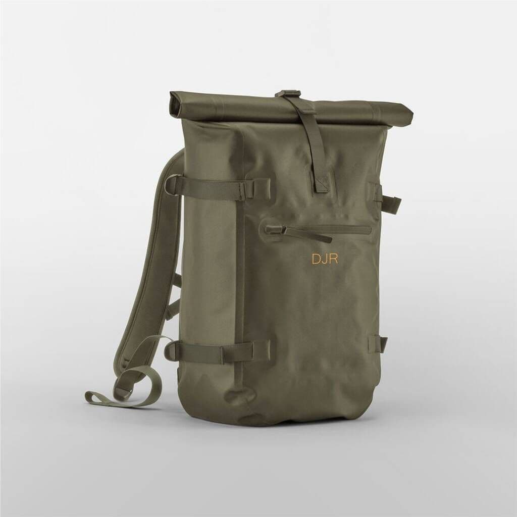 Green roll-top backpack with 'DJR' branding on a light gray background