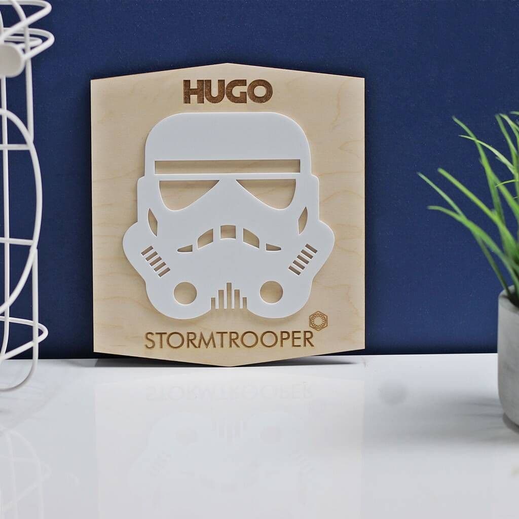 Wooden plaque with stormtrooper helmet design and 'Hugo' text on a blue background